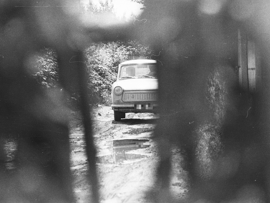 Aufnahme eines sich nähernden Trabants mit zwei Insassen. Fotografiert wurde aus einem Versteck heraus.